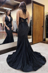 Long Beaded Black Prom Dress with Sparkly Halter and Backless Design Featuring Appliques