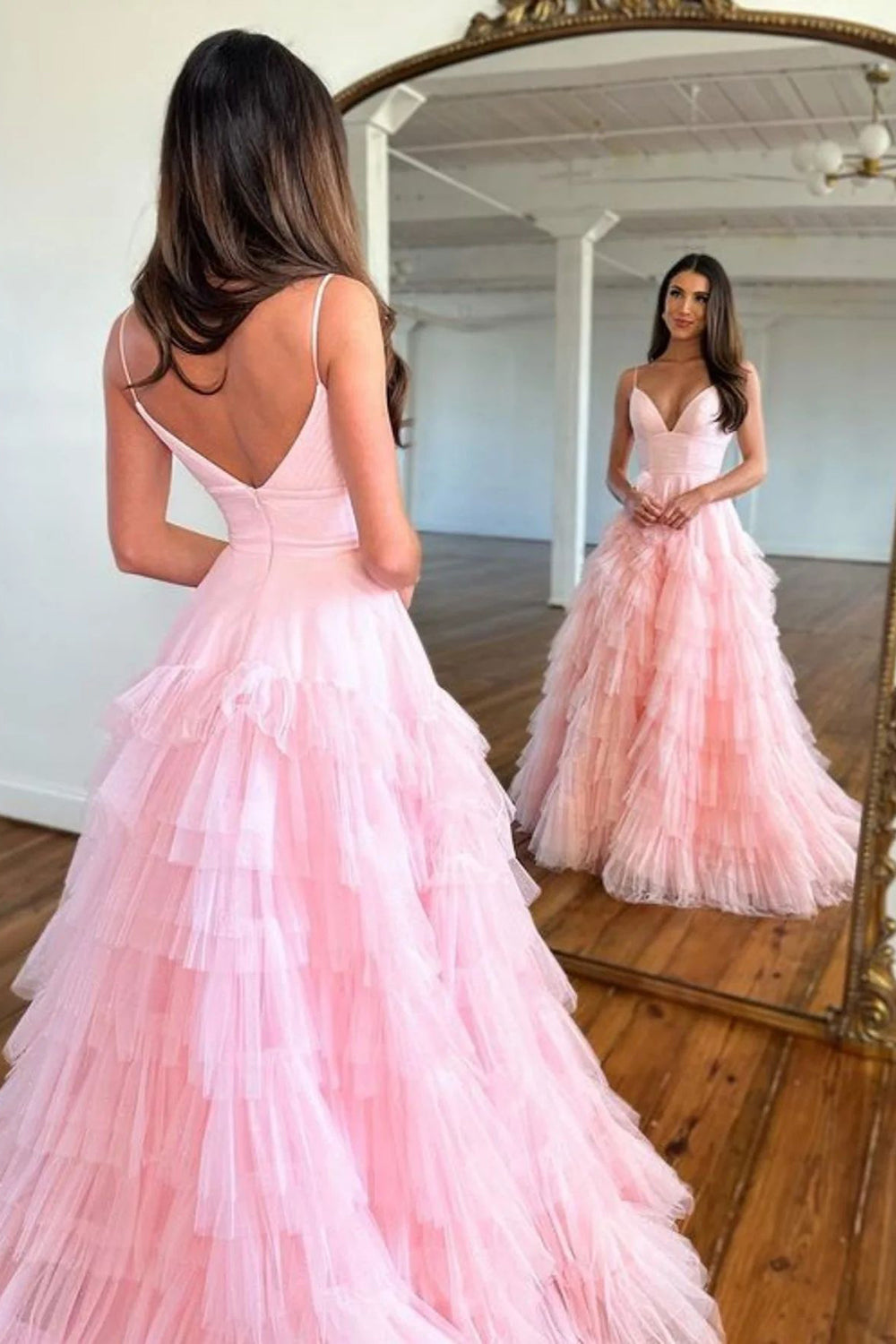 Pink long prom dress with spaghetti straps and ruffles in an A-line silhouette