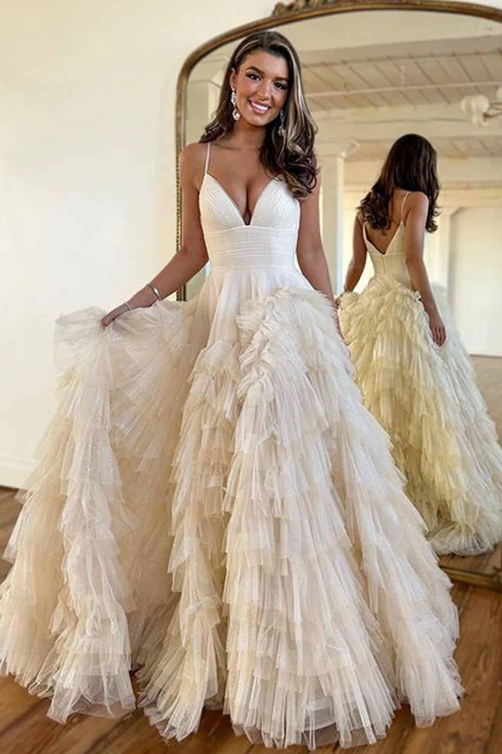 Pink long prom dress with spaghetti straps and ruffles in an A-line silhouette