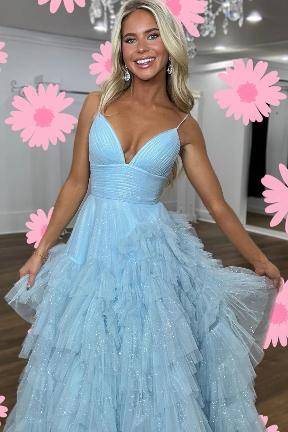 Pink long prom dress with spaghetti straps and ruffles in an A-line silhouette