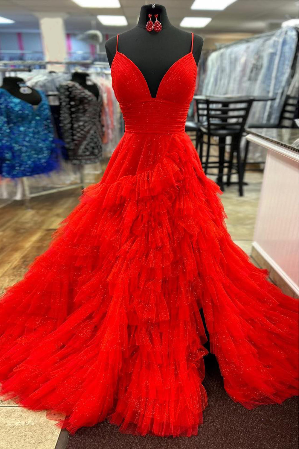 Pink long prom dress with spaghetti straps and ruffles in an A-line silhouette