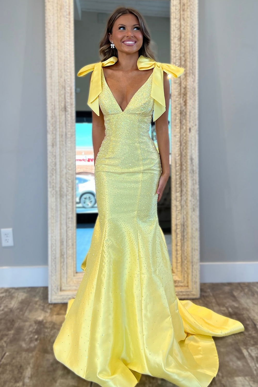 Yellow Beaded Mermaid Prom Dress with Glitter and Bows in a Deep V-Neck