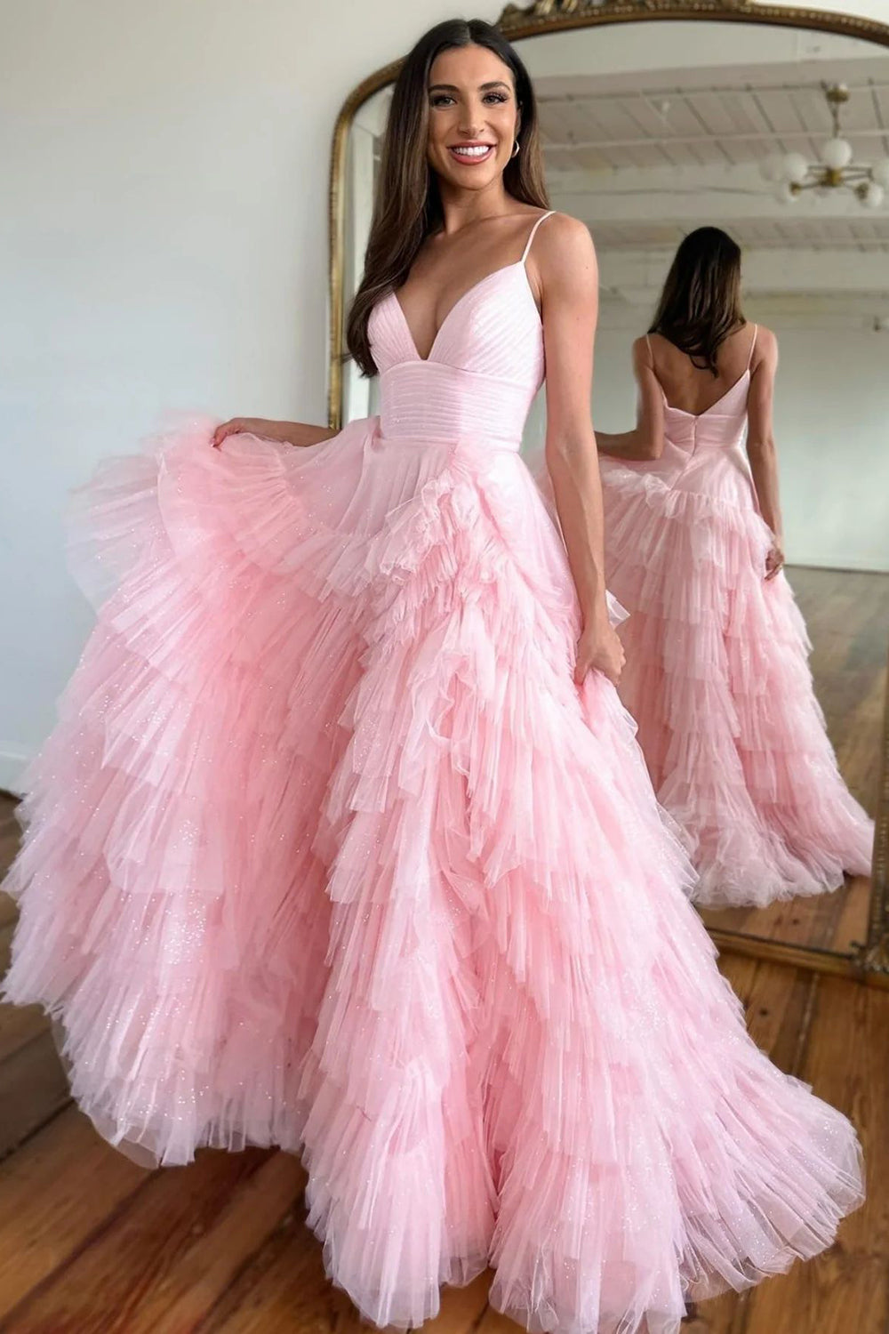 Pink long prom dress with spaghetti straps and ruffles in an A-line silhouette