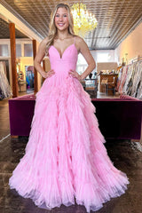 Pink long prom dress with spaghetti straps and ruffles in an A-line silhouette