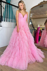 Pink long prom dress with spaghetti straps and ruffles in an A-line silhouette