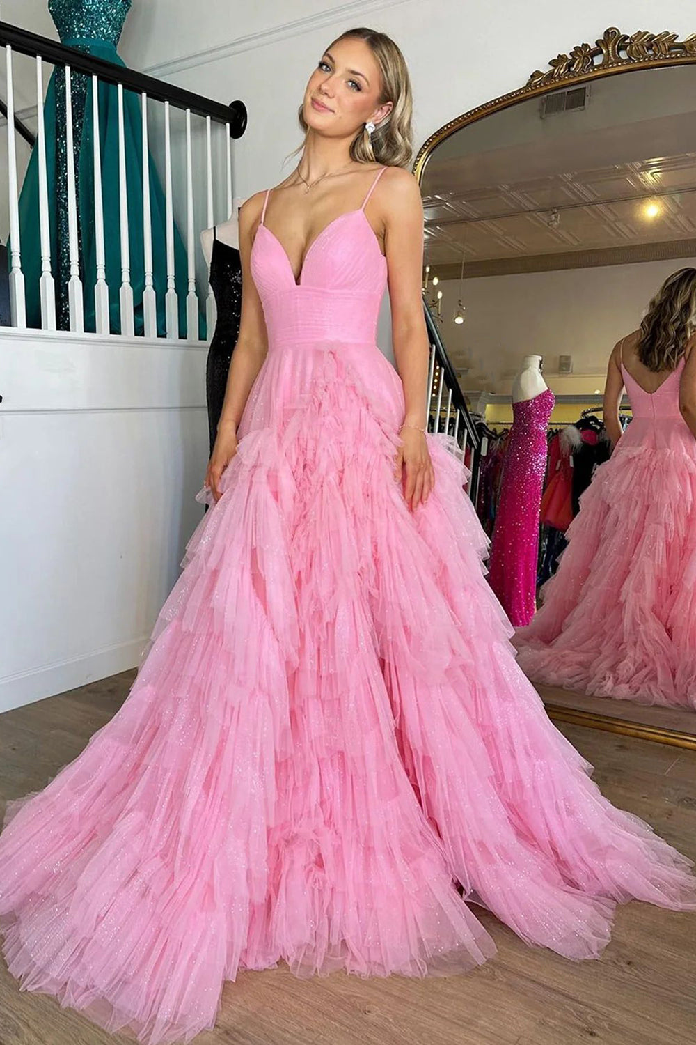 Pink long prom dress with spaghetti straps and ruffles in an A-line silhouette