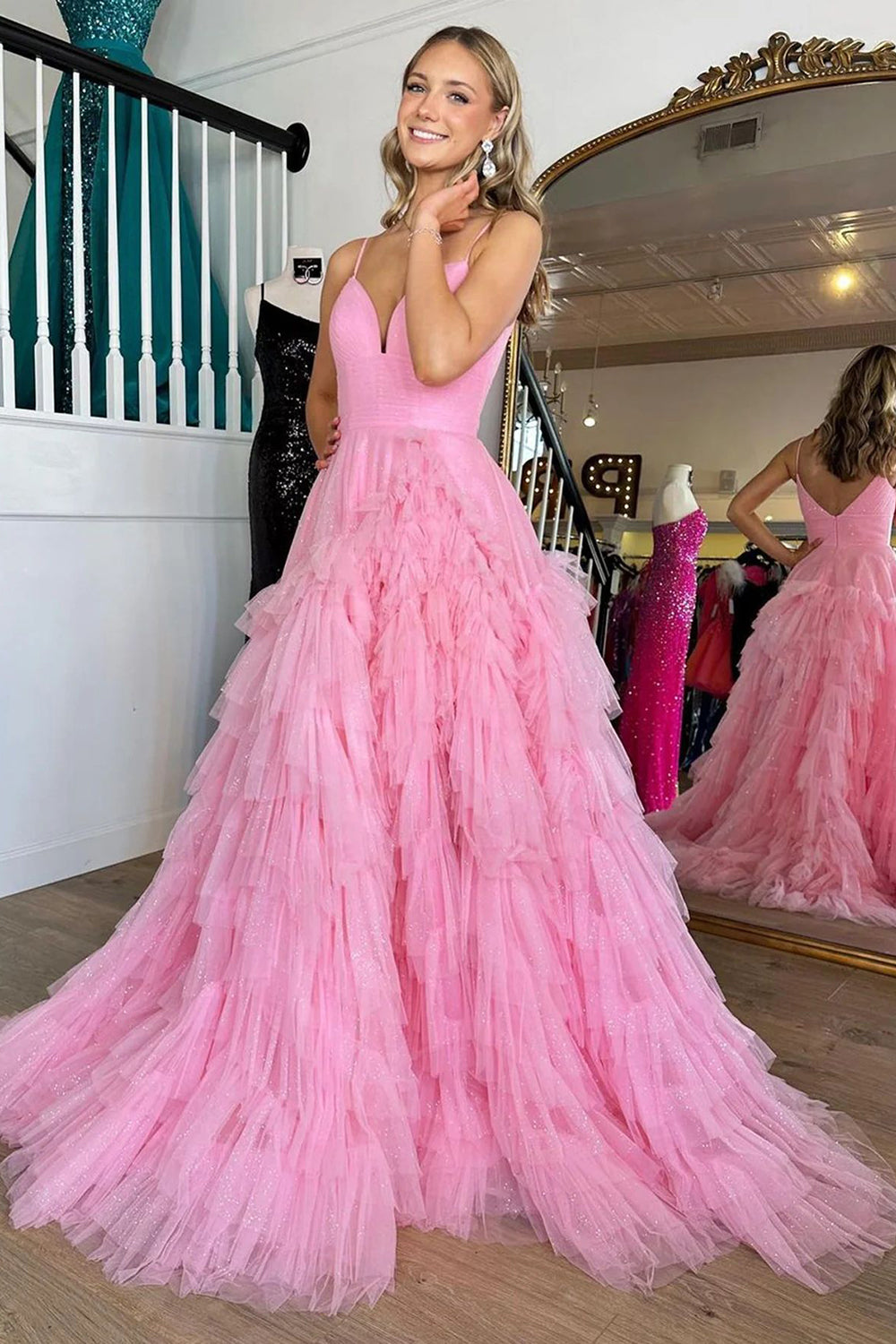 Pink long prom dress with spaghetti straps and ruffles in an A-line silhouette