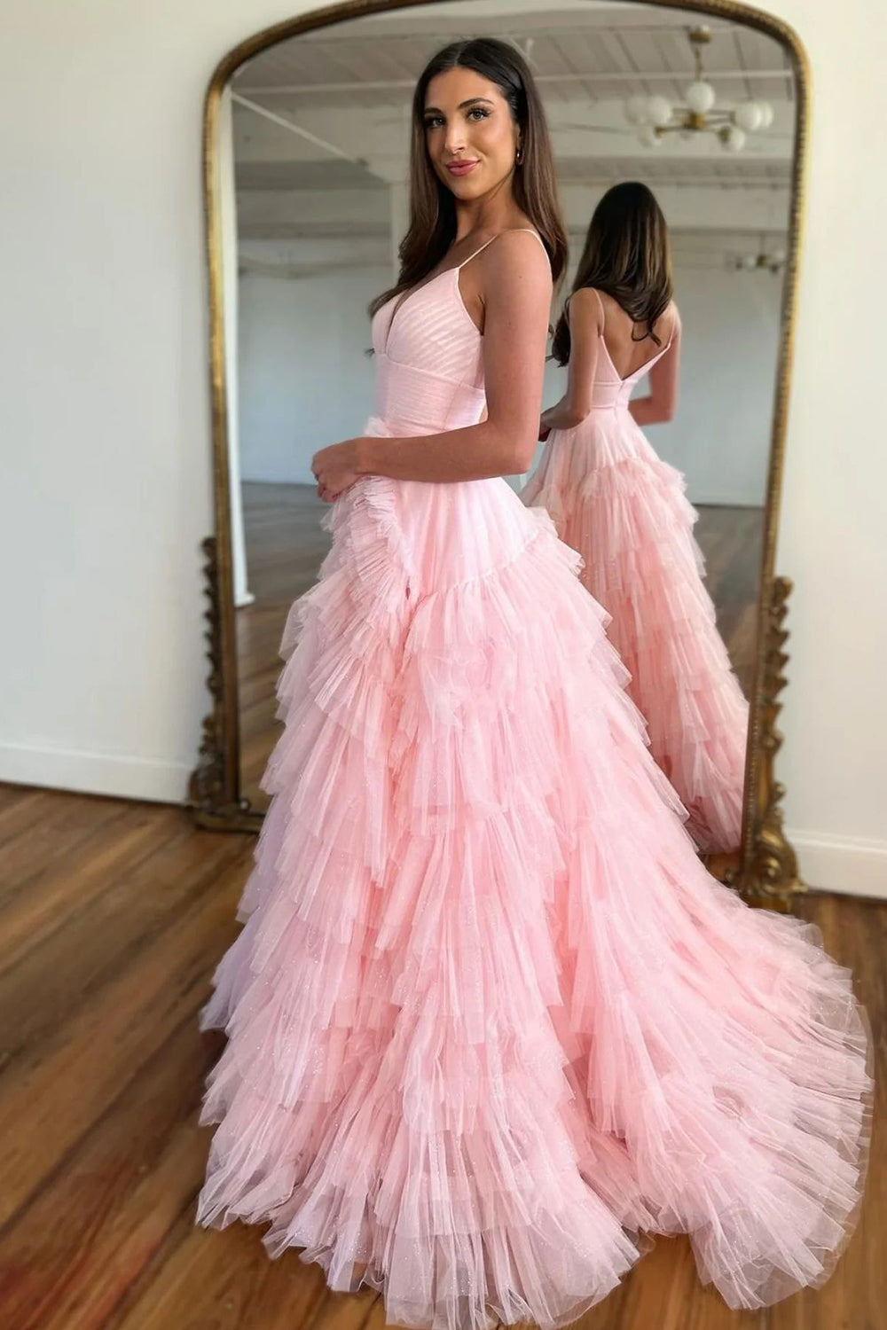 Pink long prom dress with spaghetti straps and ruffles in an A-line silhouette